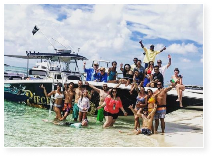 Group enjoying water sports on Pieces of 8 Tours private boat charter in Nassau Bahamas